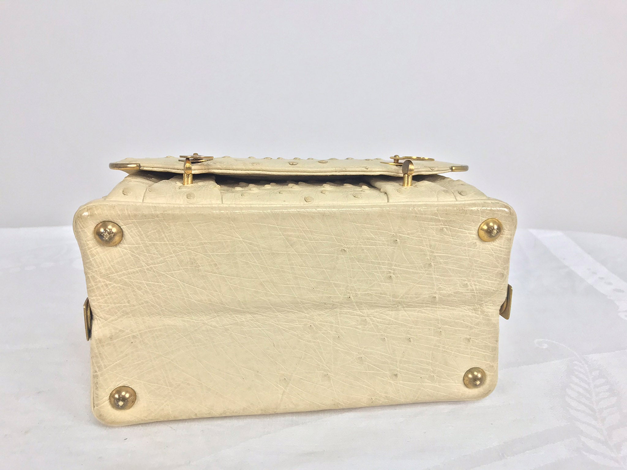 KWANPEN OSTRICH HANDBAG, gold tone hardware with single top handle, flip  lock closures at the front, cream leather lining, with two sections and two  internal pockets one with zip, plus and external